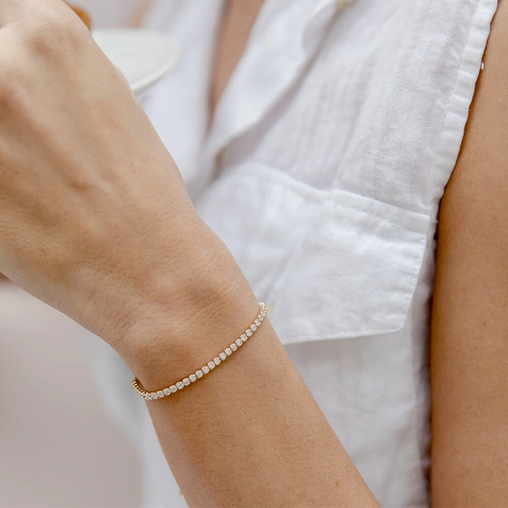 Moissanite half tennis bolo bracelet worn on the wrist.