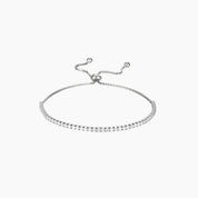 Moissanite half tennis bolo bracelet in white gold vermeil, full product view.