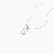 Moissanite initial necklace in white gold vermeil, close-up detail.