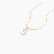 Moissanite initial necklace in yellow gold vermeil, close-up detail.