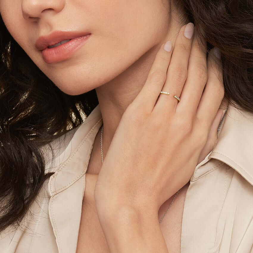 Moissanite open ring worn on a finger.