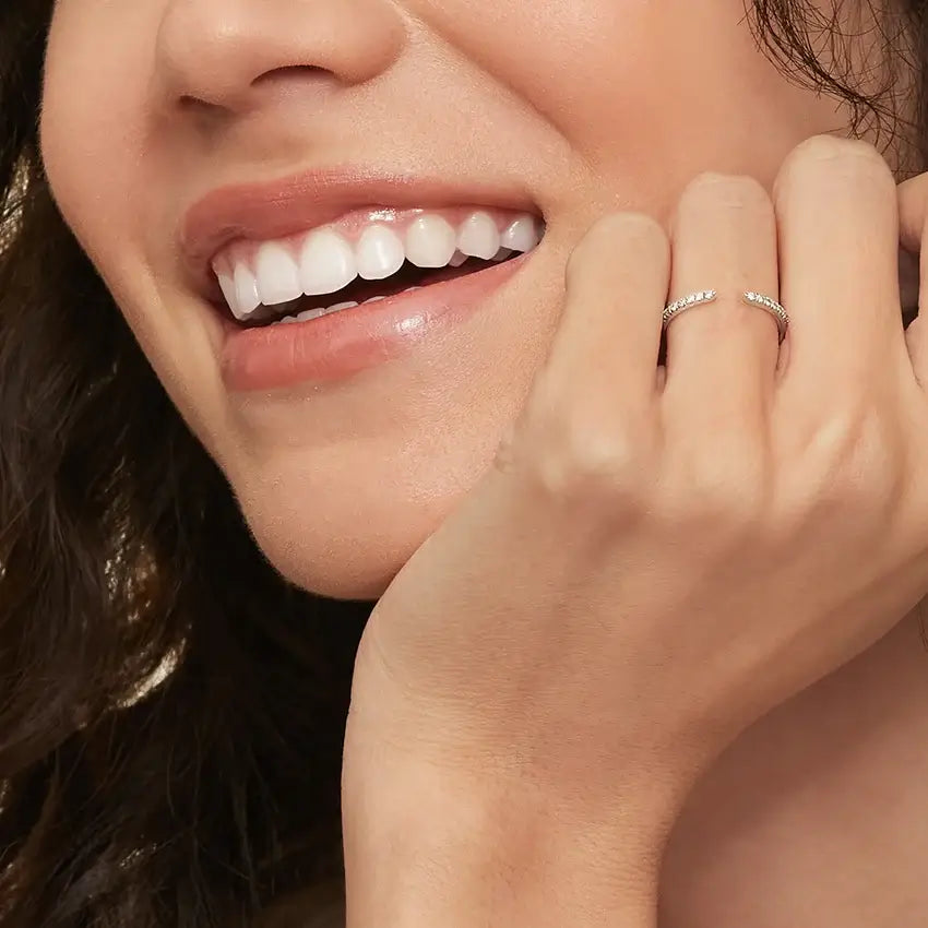 Moissanite open ring worn on a finger.