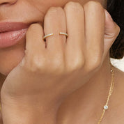 Moissanite open ring worn on a finger.