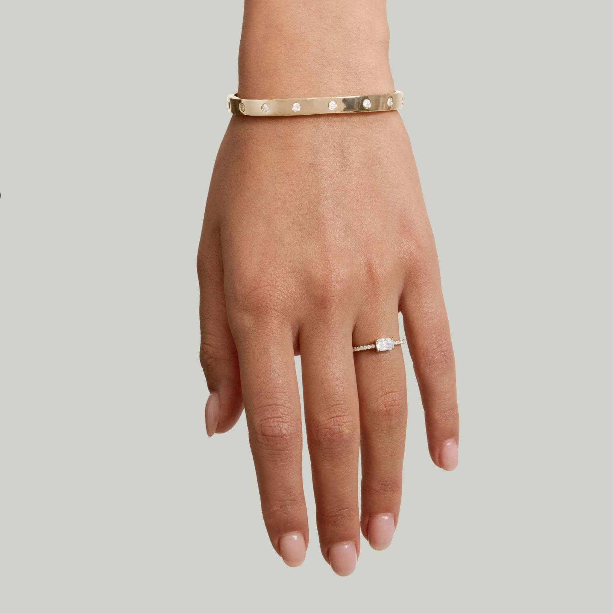 Moissanite station bangle bracelet worn on the wrist.