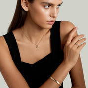 Moissanite station bangle bracelet worn on the wrist.