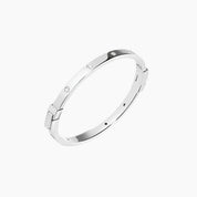 Moissanite station bangle bracelet in white gold vermeil, angled view.