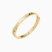 Moissanite station bangle bracelet in yellow gold vermeil, angled view.