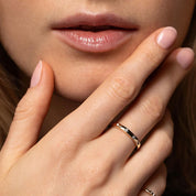 Moissanite station ring worn on a finger.