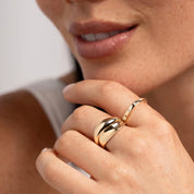 Moissanite station ring worn on a finger.