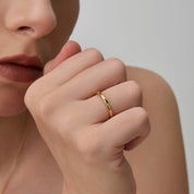 Moissanite station ring worn on a finger.