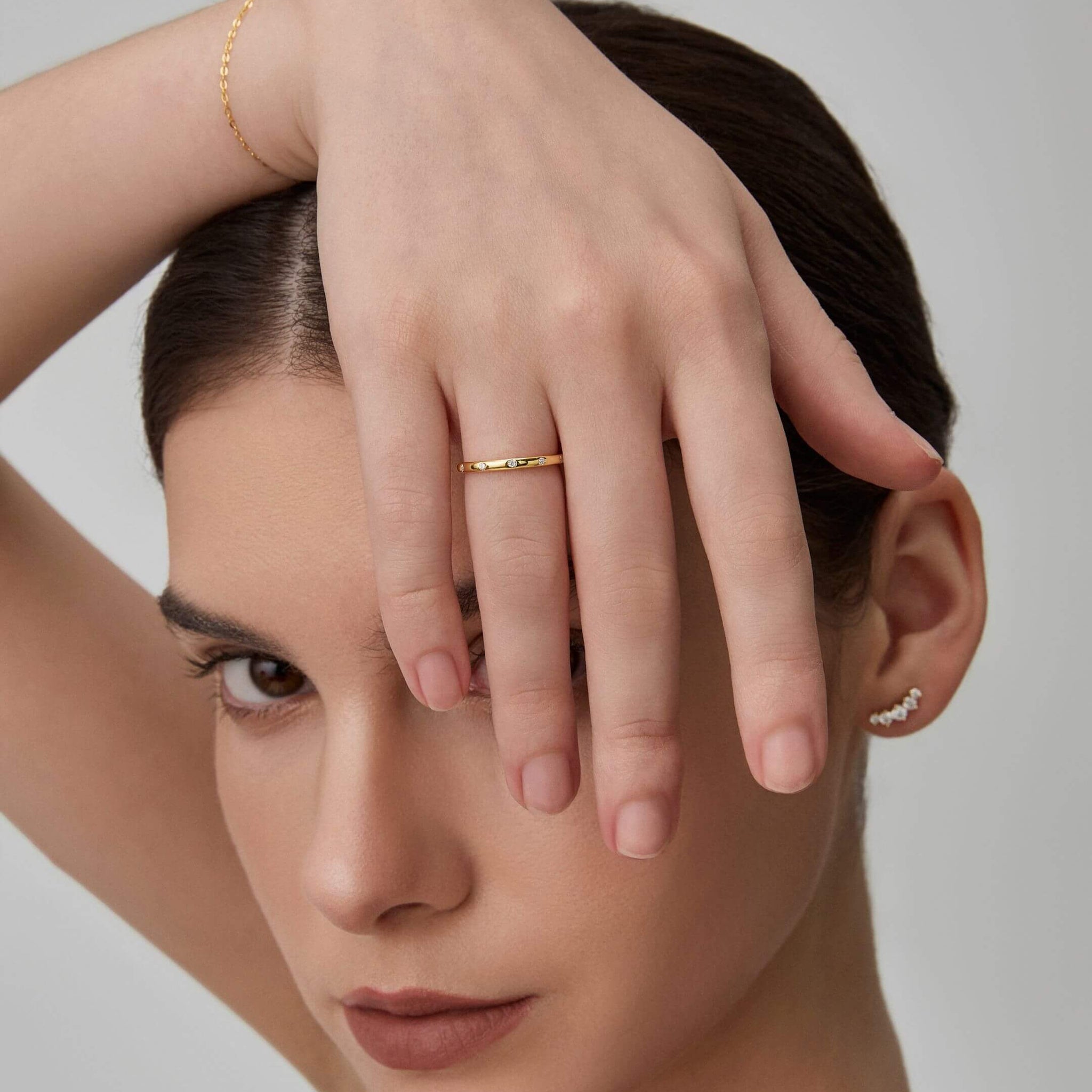 Moissanite station ring worn on a finger.