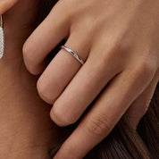 Moissanite station ring worn on a finger.