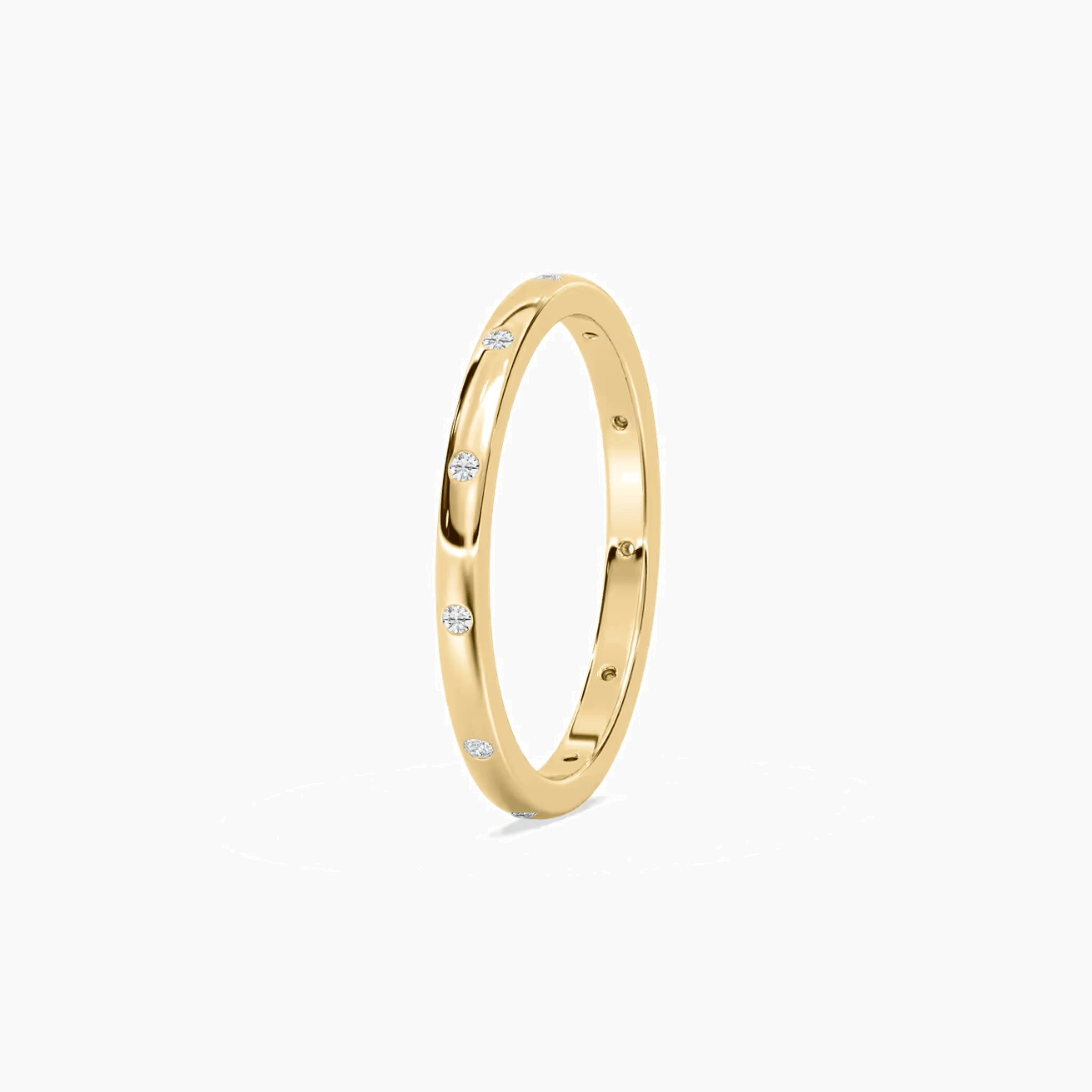 Moissanite station ring in yellow gold vermeil, side view.