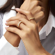 Moissanite twisted ring worn on a finger.