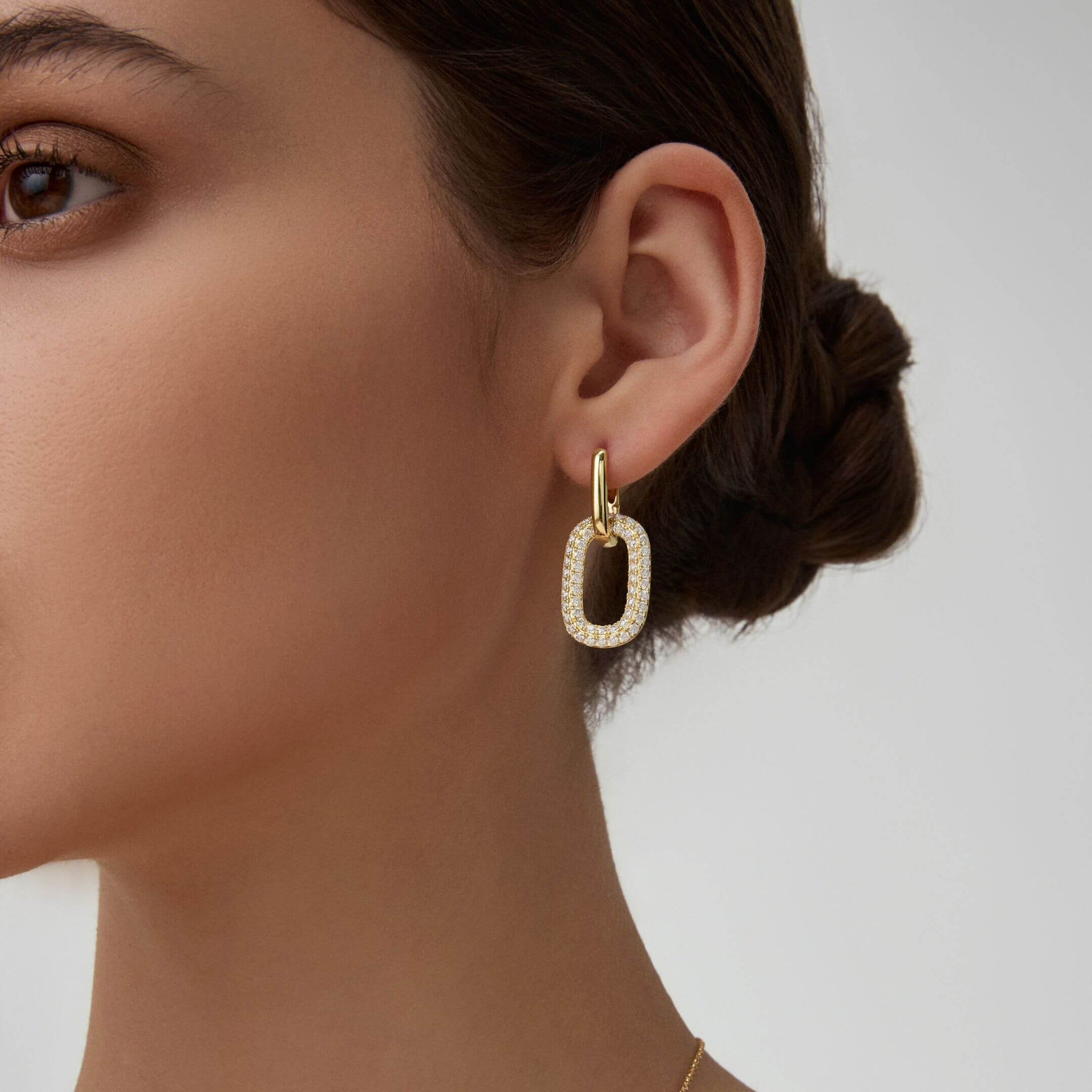 Multiway bold pavé moissanite link earrings worn on the ear.