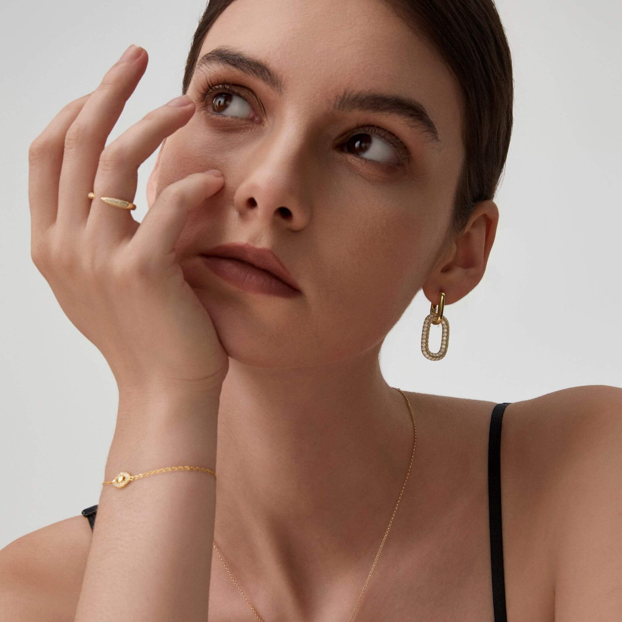 Multiway bold pavé moissanite link earrings worn on the ear.