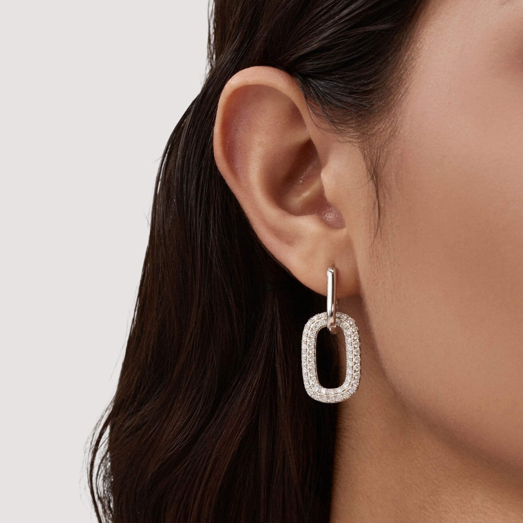 Multiway bold pavé moissanite link earrings worn on the ear.