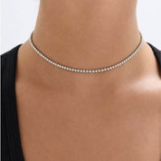 Multiway moissanite tennis choker and bracelet worn at the neckline.