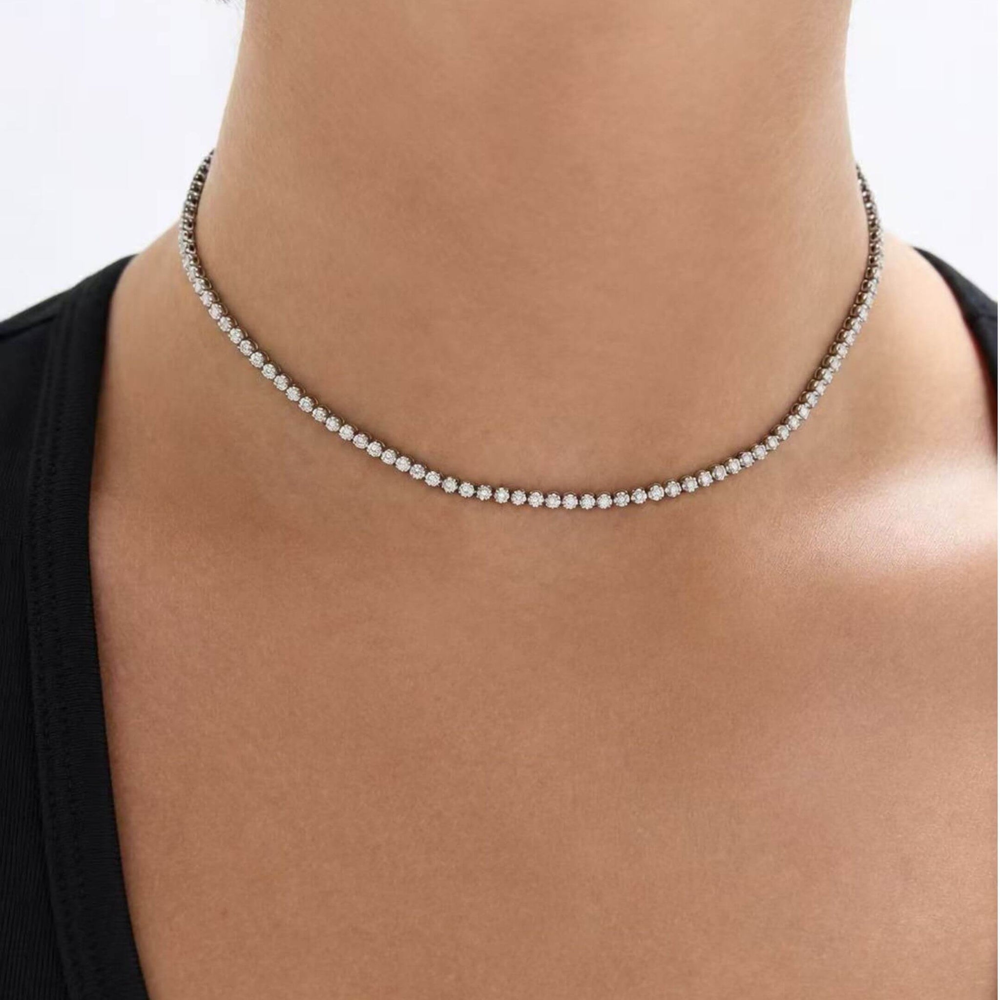 Multiway moissanite tennis choker and bracelet worn at the neckline.