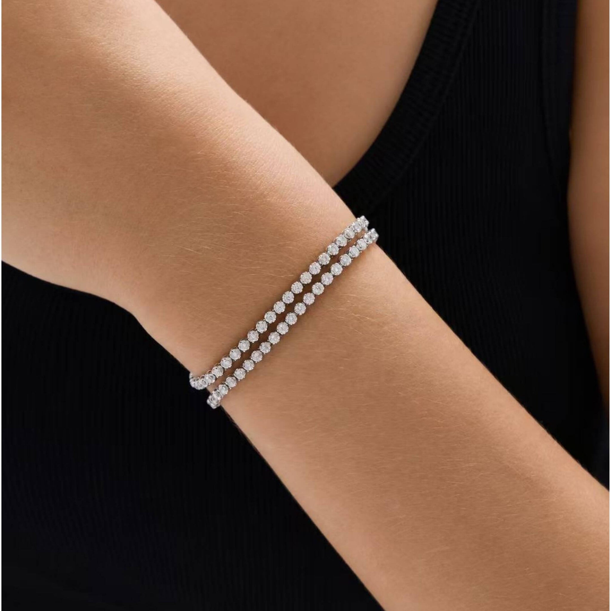 Multiway moissanite tennis choker and bracelet wrapped around the wrist in the bracelet configuration.