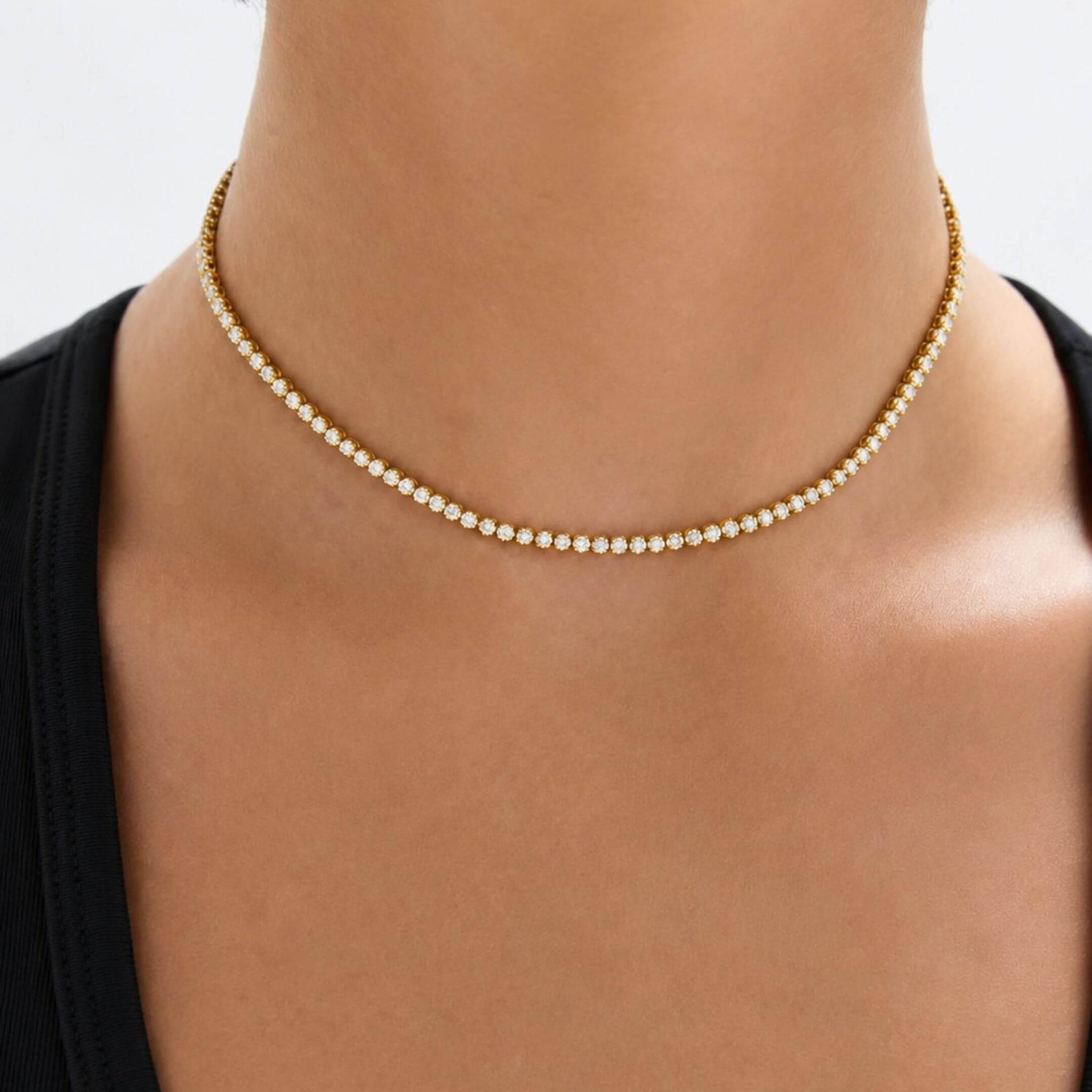 Multiway moissanite tennis choker and bracelet worn at the neckline.