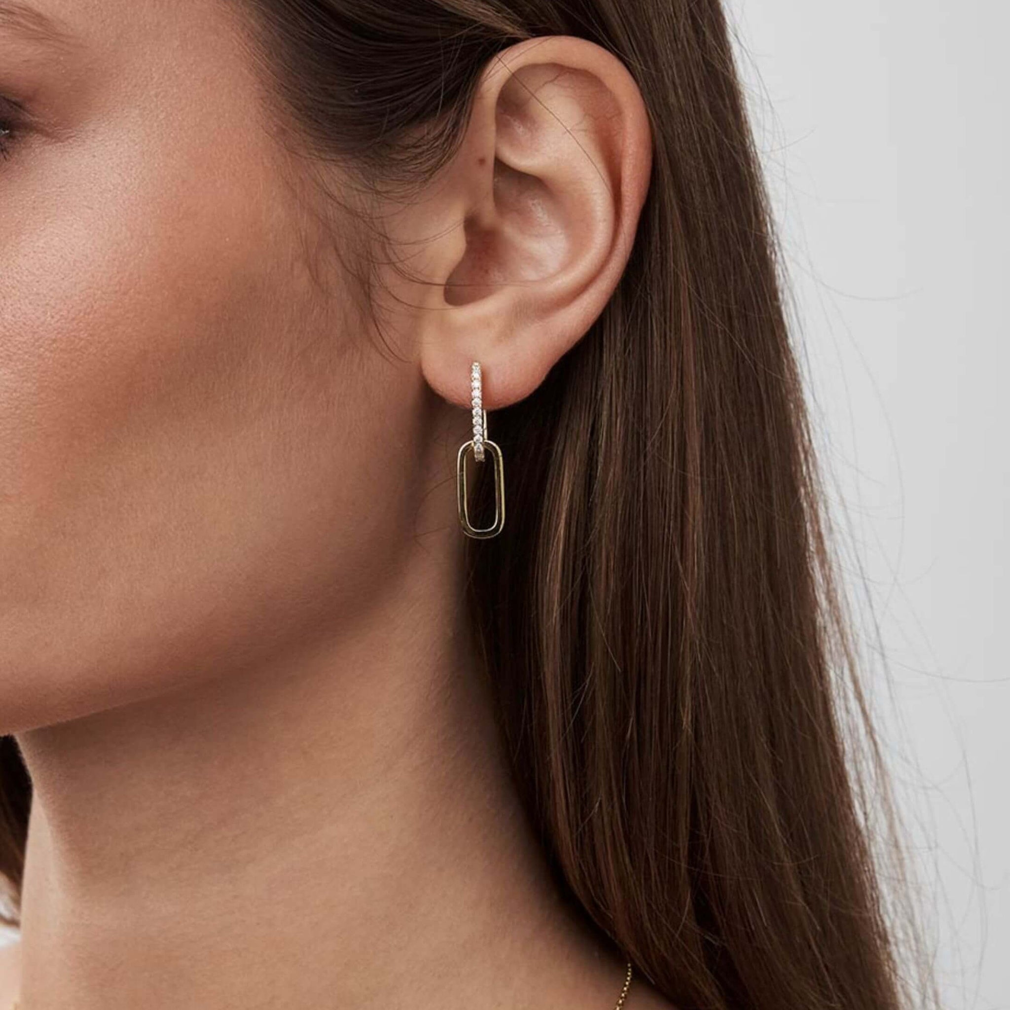 Multiway pavé moissanite link earrings worn on the ear.