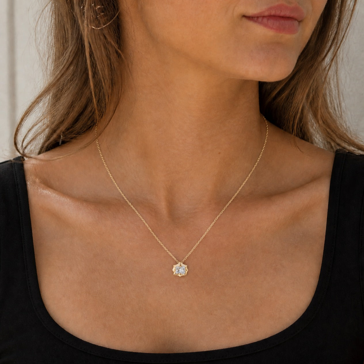 2 ct East-West Radiant-Cut Moissanite Bezel-Prong Pendant Necklace in 18k yellow gold vermeil, worn on a model.