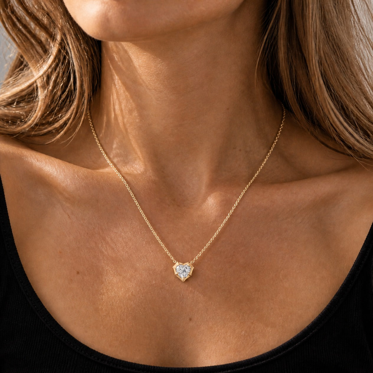 2 ct Heart-Cut Moissanite Bezel-Prong Pendant Necklace in 18k yellow gold vermeil, worn on a model.