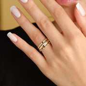 Oval-cut moissanite bezel dome ring worn on a finger.