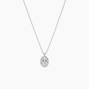 Oval-cut moissanite bezel pendant necklace in white gold vermeil, full product view.