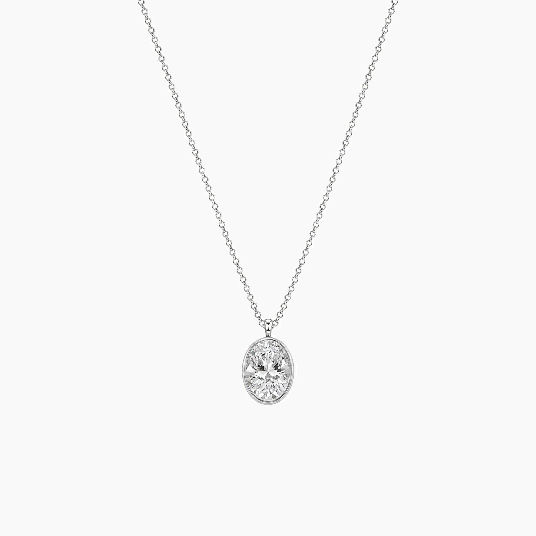 Oval-cut moissanite bezel pendant necklace in white gold vermeil, full product view.