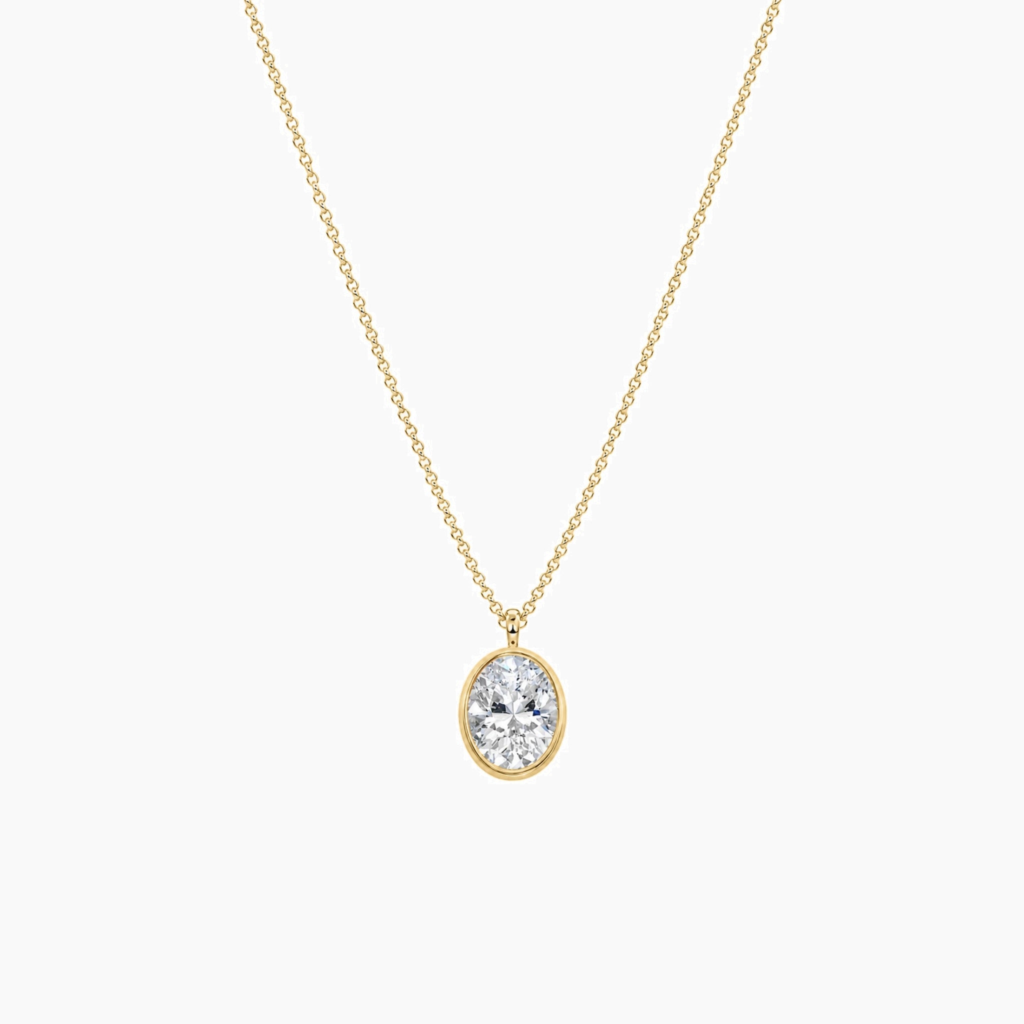 Oval-cut moissanite bezel pendant necklace in yellow gold vermeil, full product view.
