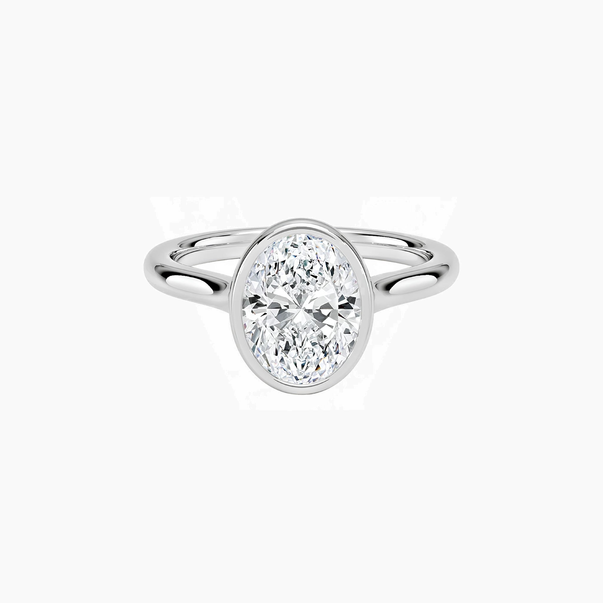Oval-cut moissanite bezel solitaire ring in white gold vermeil, front view.