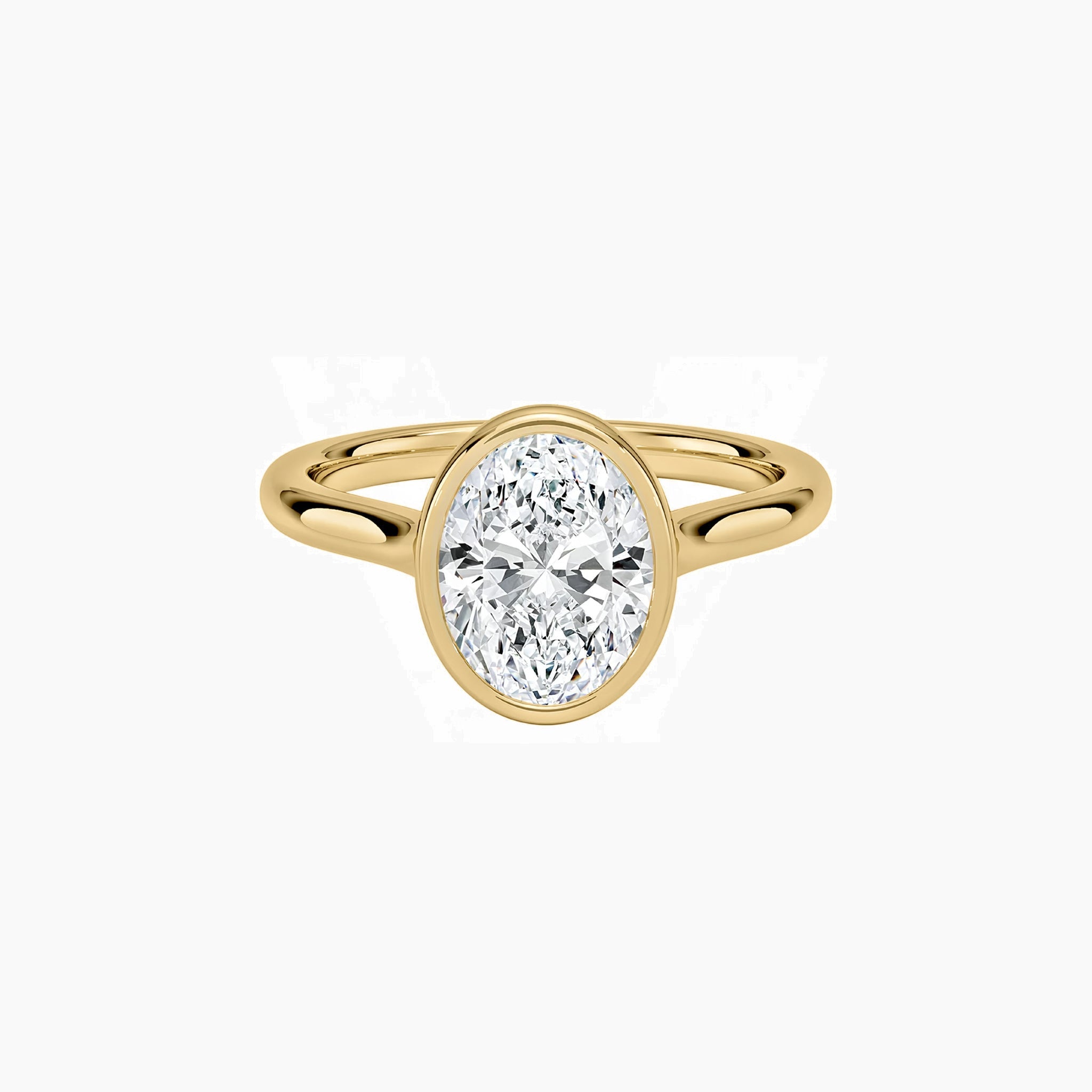 Oval-cut moissanite bezel solitaire ring in yellow gold vermeil, front view.