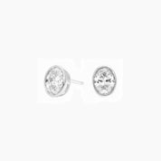 Oval-cut moissanite bezel stud earrings in white gold vermeil, front and side views.