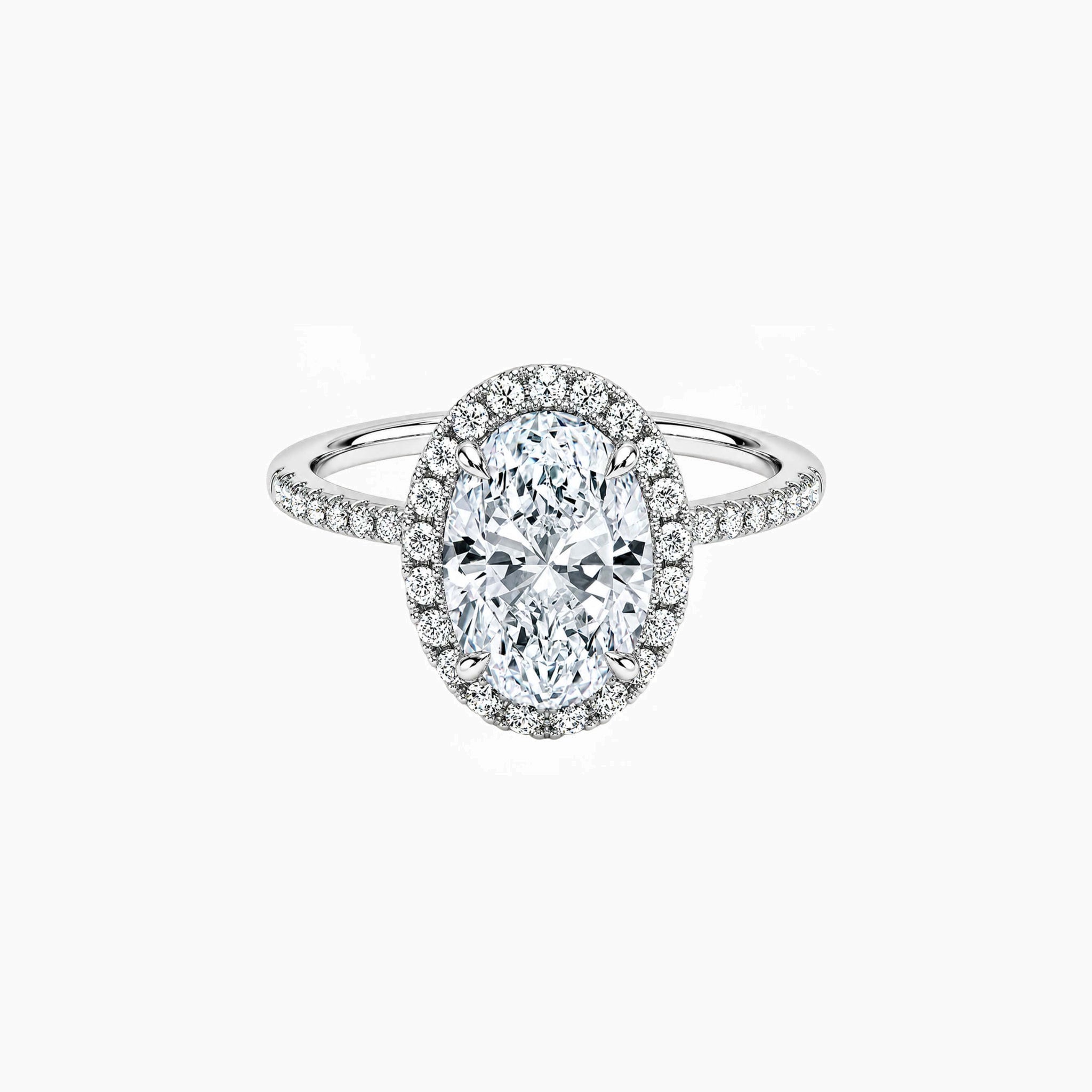 Oval-cut moissanite halo ring with pavé band in white gold vermeil, front view.