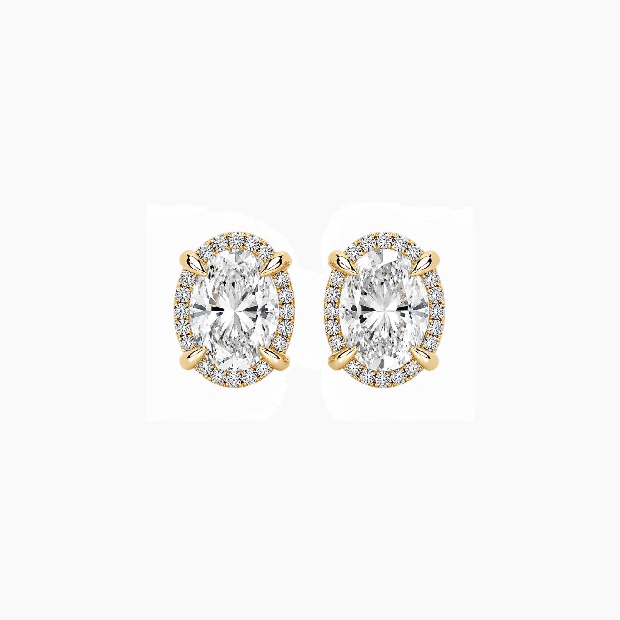Oval-cut moissanite halo stud earrings in yellow gold vermeil, front view.