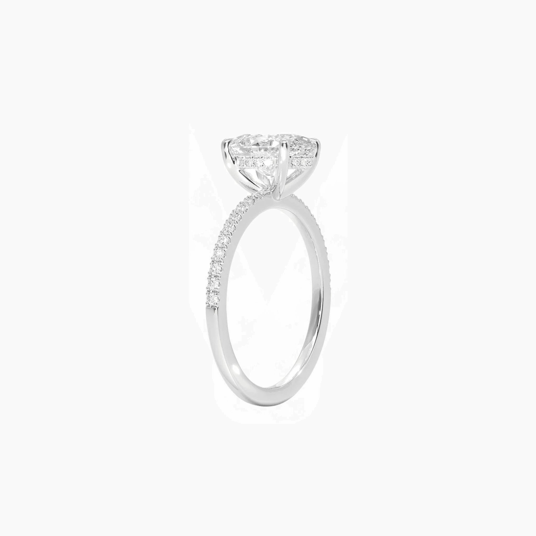 Oval-cut moissanite hidden halo ring with pavé band in white gold vermeil, side view.