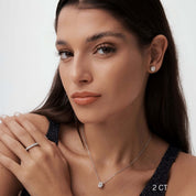 Oval-cut moissanite pendant necklace worn at the neckline.