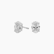 Oval-cut moissanite stud earrings in white gold vermeil, front and side views.