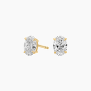 Oval-cut moissanite stud earrings in yellow gold vermeil, front and side views.