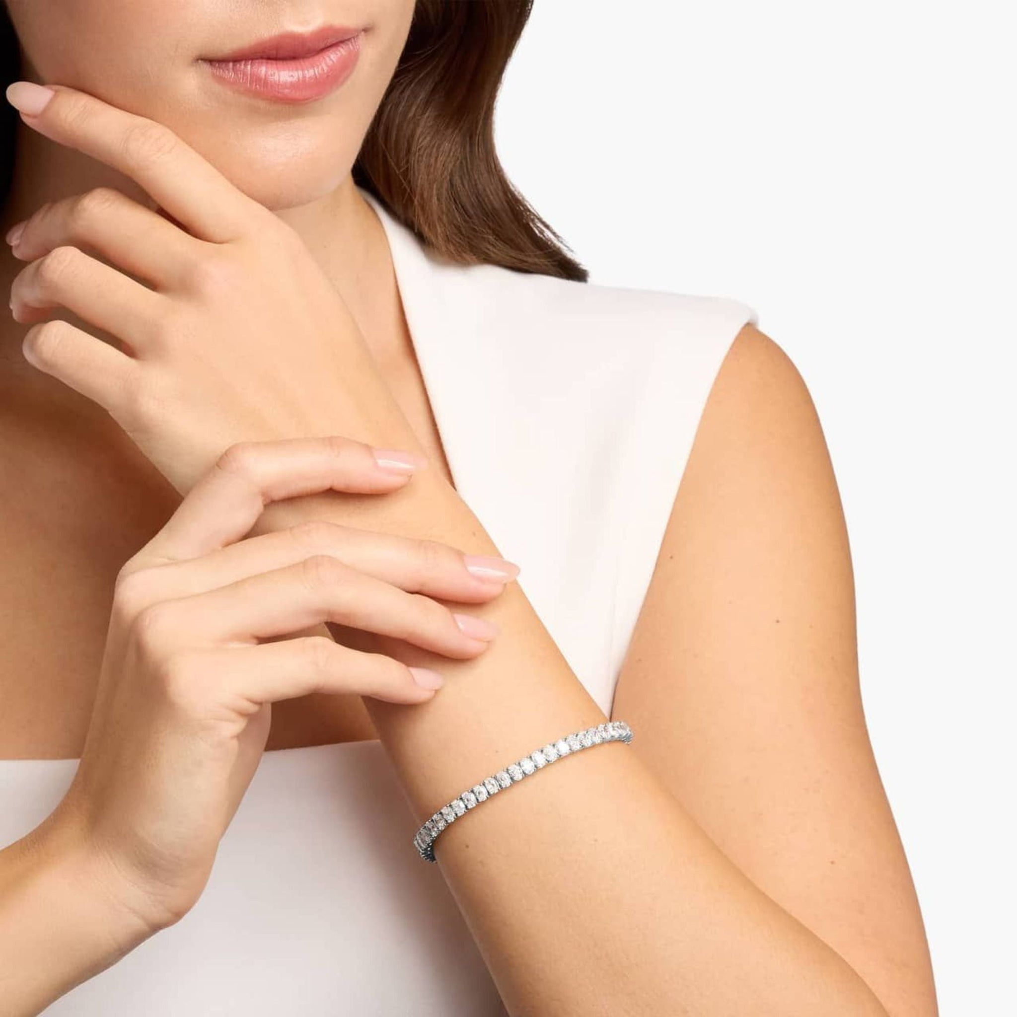 Oval-cut moissanite tennis bracelet worn on the wrist.