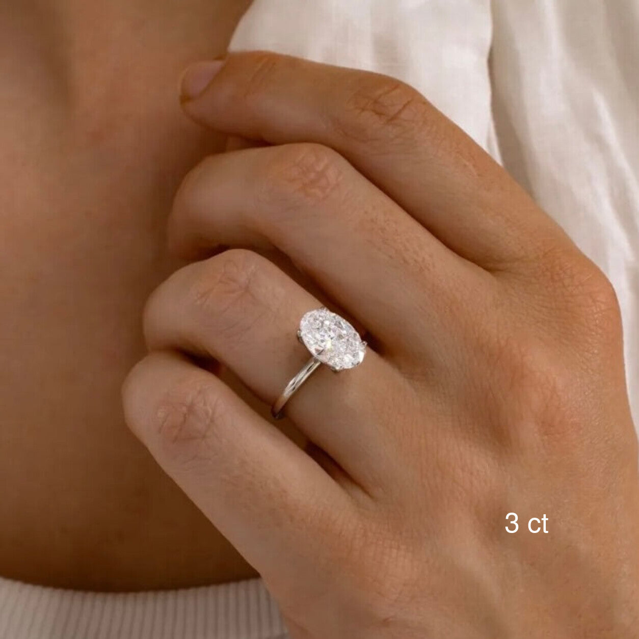 3 ct oval-cut moissanite solitaire ring worn on a hand