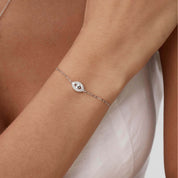 Pavé moissanite evil eye bracelet worn on the wrist.