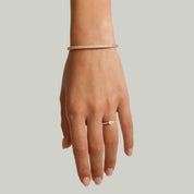 Pavé moissanite stackable bangle worn on the wrist.