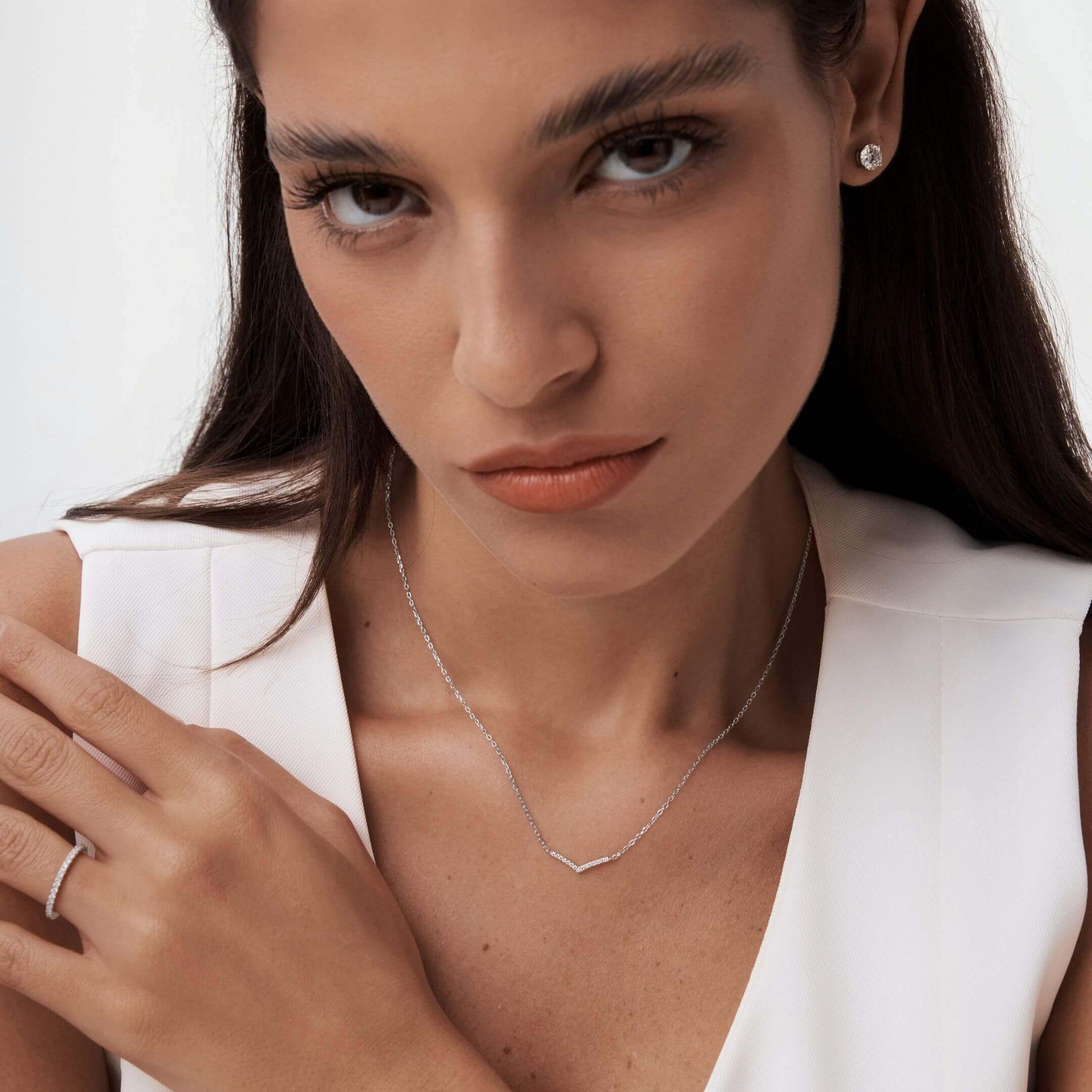 Pavé moissanite wishbone necklace worn at the neckline.