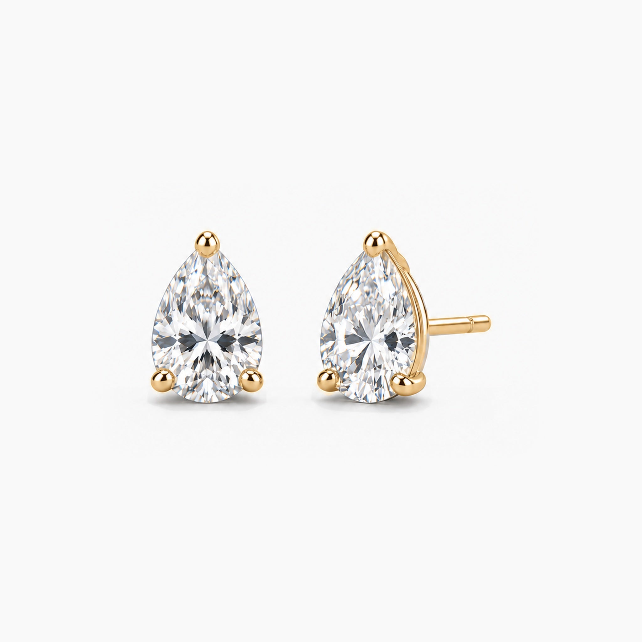 Pear-cut lab-grown diamond stud earrings in 14k yellow gold, front and three-quarter views.