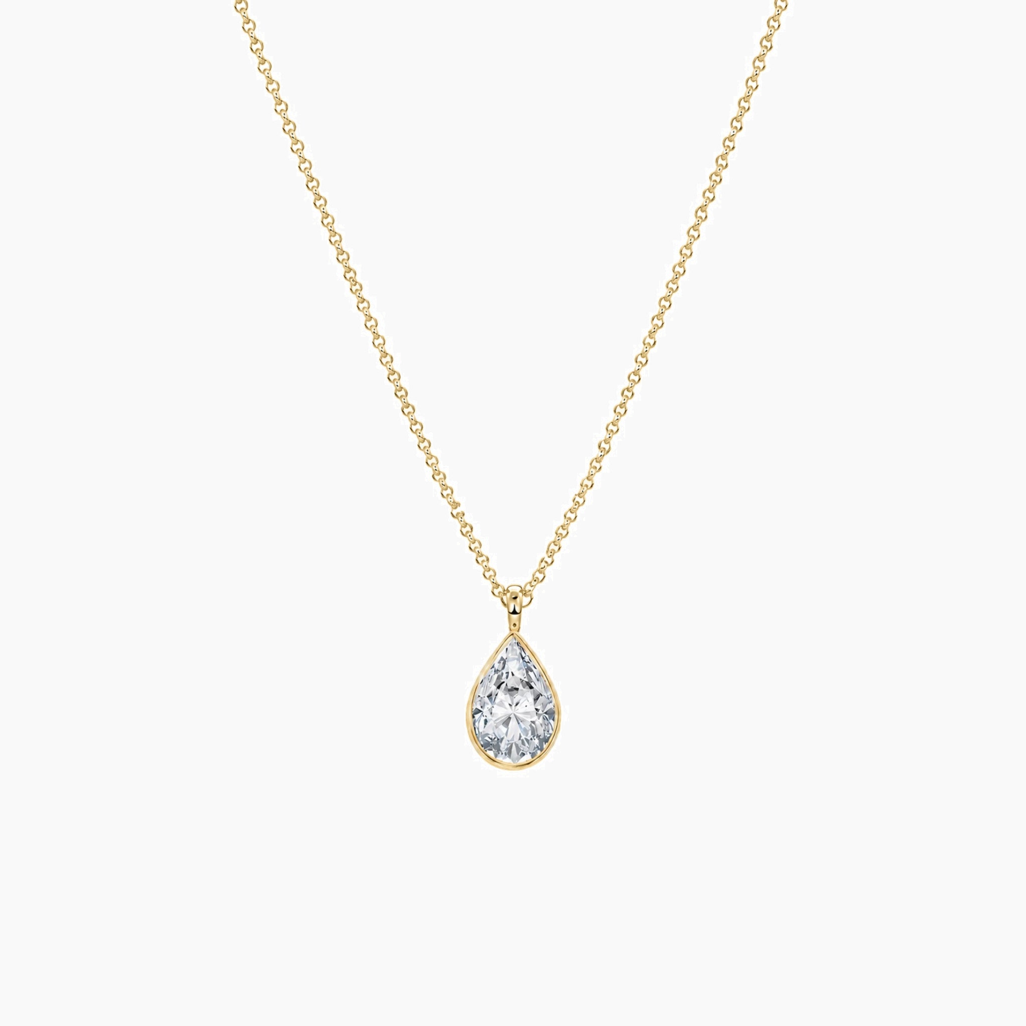Pear-cut moissanite bezel pendant necklace in yellow gold vermeil, full product view.