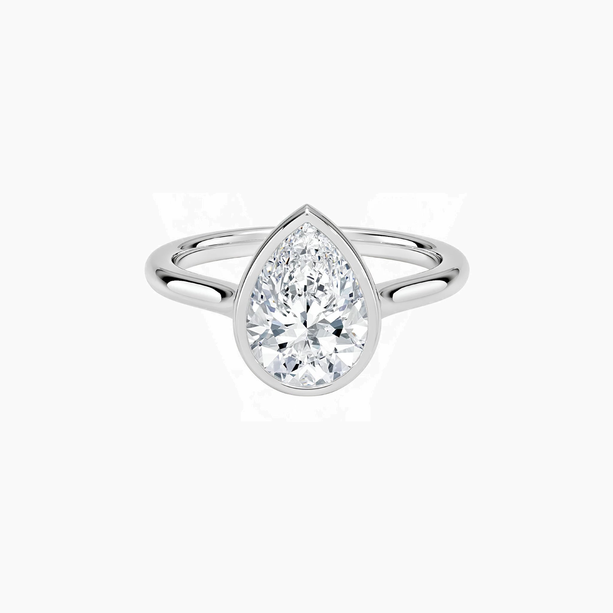 Pear-cut moissanite bezel solitaire ring in white gold vermeil, front view.