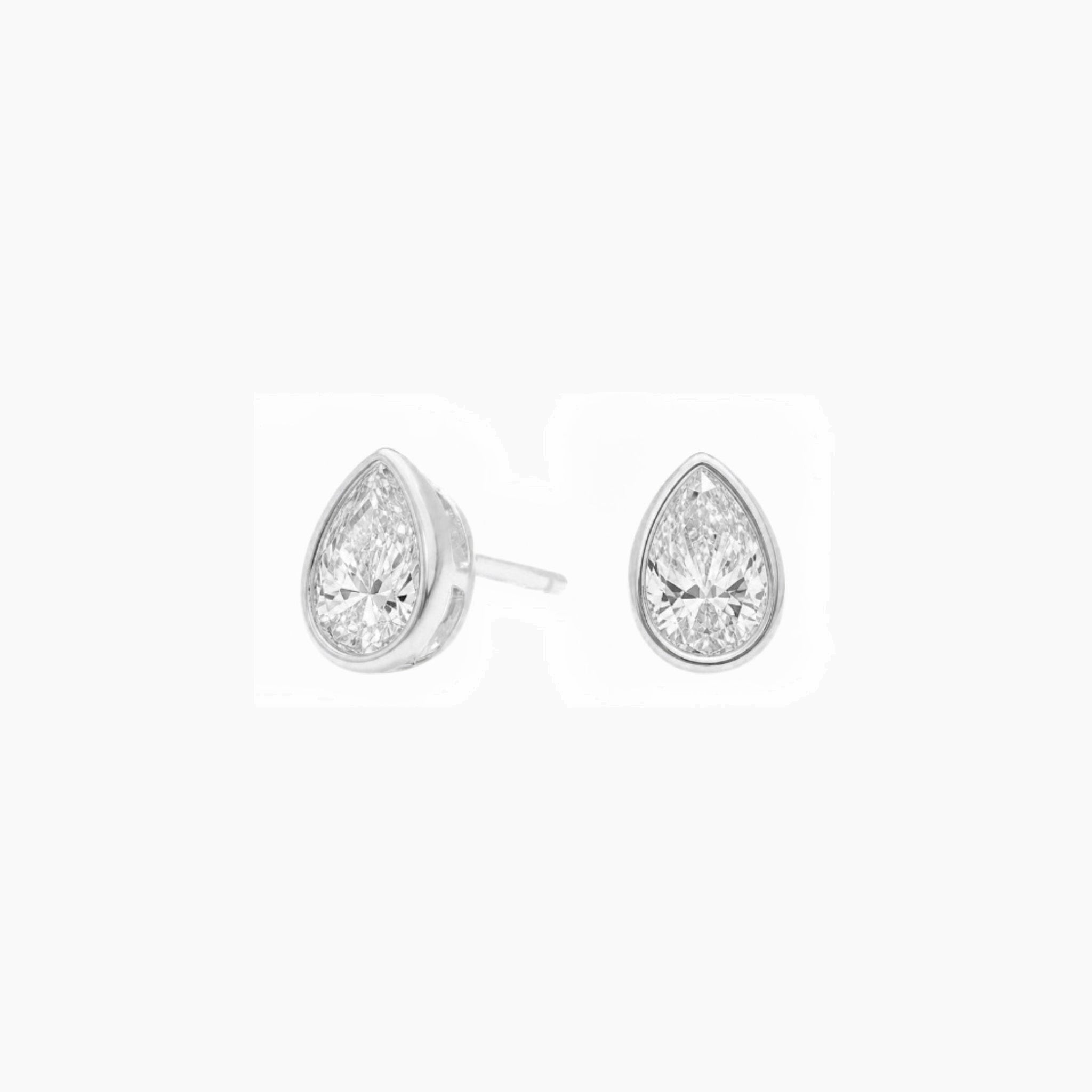 Pear-cut moissanite bezel stud earrings in white gold vermeil, front and side views.